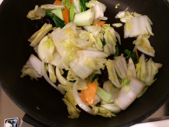 白菜、玉ねぎ、にんじん、きくらげ、チンゲンサイを入れ、1分半ほど炒めます